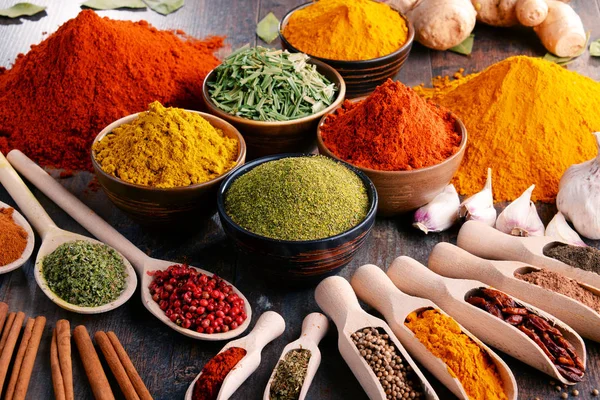 Variety of spices and herbs on kitchen table — Stock Photo, Image
