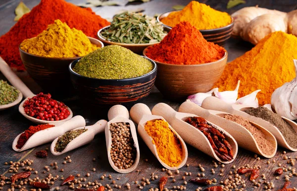 Variety of spices and herbs on kitchen table — Stock Photo, Image