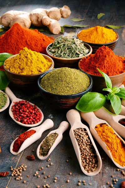 Variety of spices and herbs on kitchen table — Stock Photo, Image