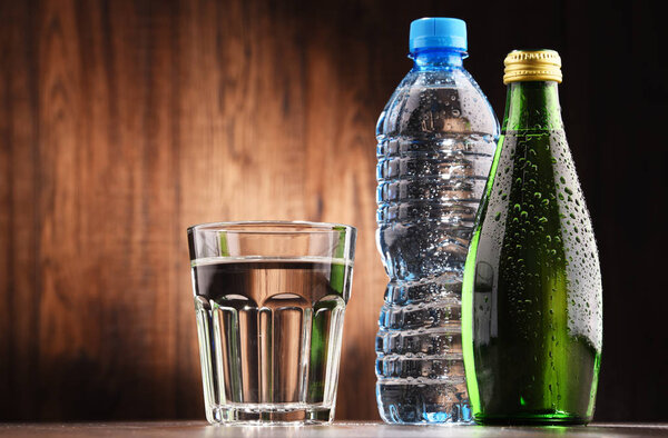 Composition with glass and bottles of mineral water