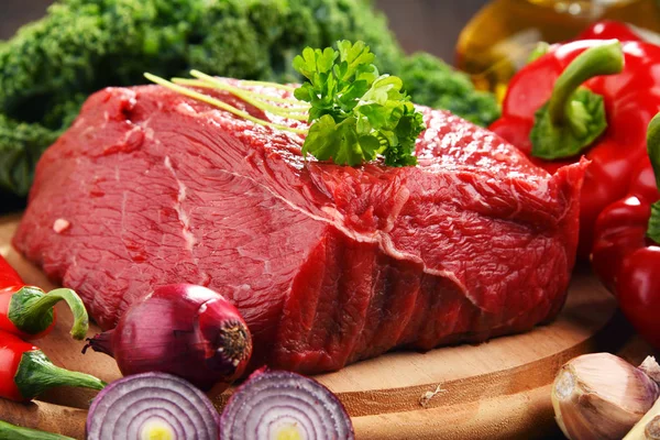 Piece of beef and spices on cutting board — Stock Photo, Image