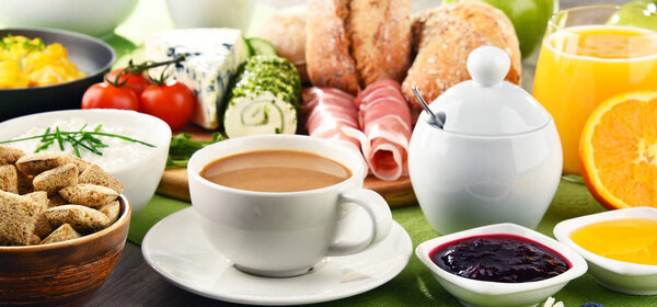 Breakfast served with coffee, cheese, cereals and scrambled eggs