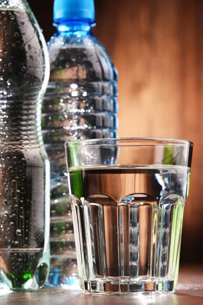 Composition with glass and bottles of mineral water — Stock Photo, Image