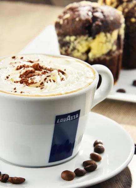 Cup of Lavazza coffee and muffins — Stock Photo, Image