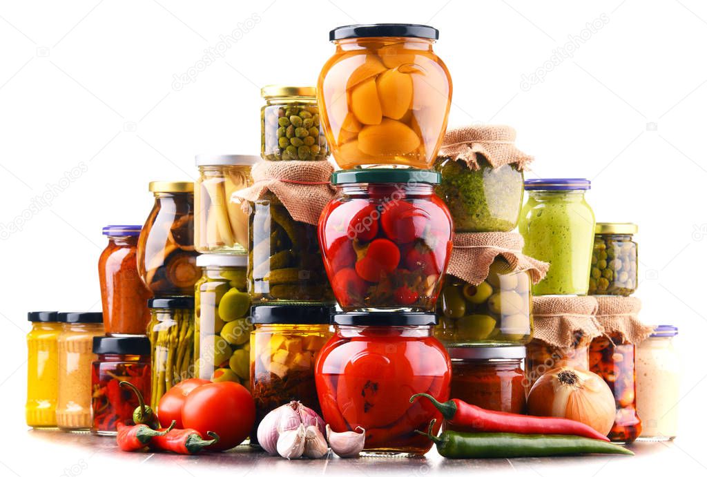Jars with variety of pickled vegetables  isolated on white