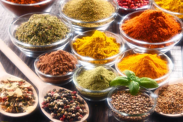 Variety of spices and herbs on kitchen table — Stock Photo, Image