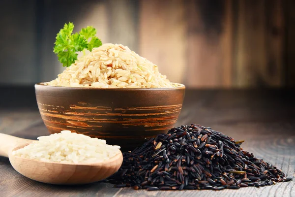 Composition with bowl of rice on wooden table — Stock Photo, Image