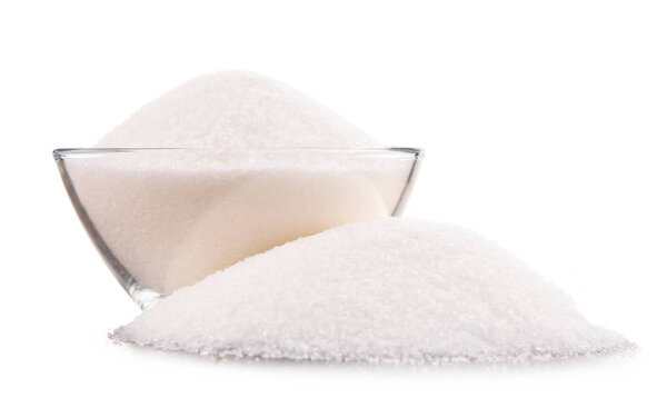 Bowl of white refined sugar on white background