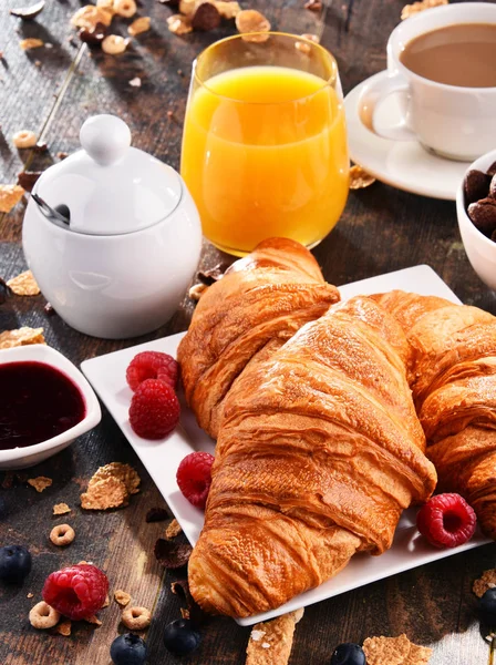 Café da manhã servido com café, suco, croissants e frutas — Fotografia de Stock