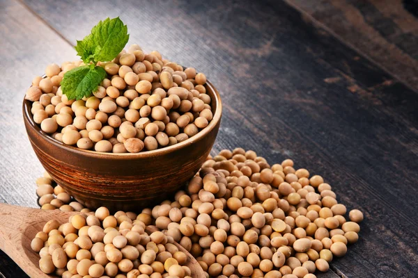 Composition with bowl of soya beans on wooden table — Stock Photo, Image