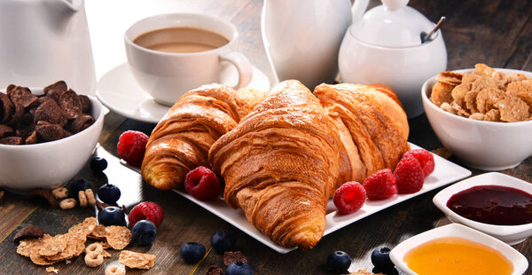 Breakfast served with coffee, juice, croissants and fruits