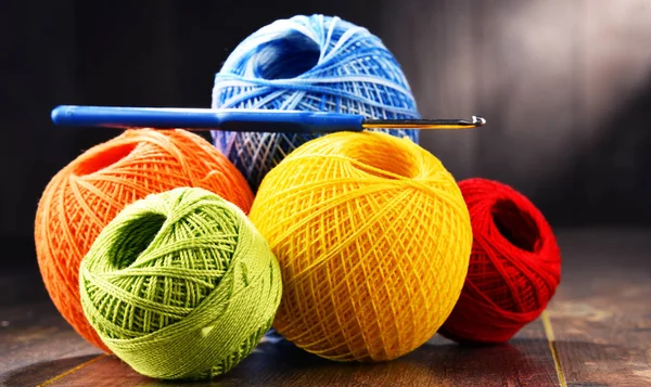 Colorful yarn for crocheting and hook on wooden table — Stock Photo, Image