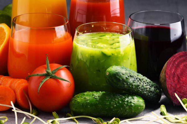 Glasses with fresh organic vegetable and fruit juices
