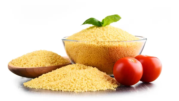 Bowl of uncooked couscous isolated on white — Stock Photo, Image