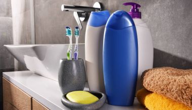 Plastic bottles of body care and beauty products in the bathroom clipart