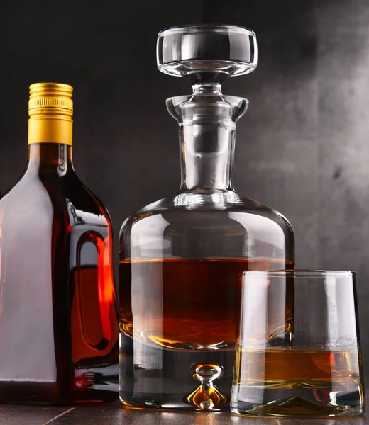 Carafe and bottles of assorted alcoholic beverages. — Stock Photo, Image