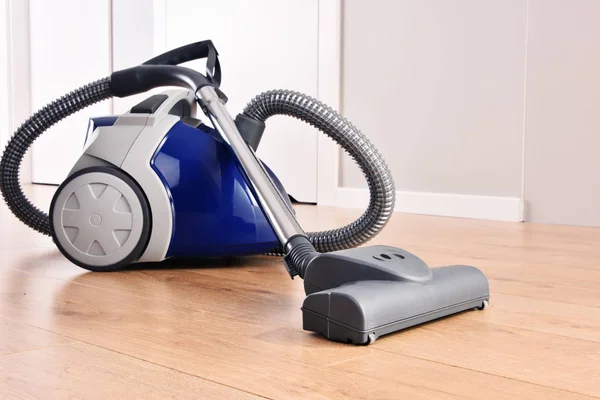 Canister vacuum cleaner for home use on the floor panels — Stock Photo, Image