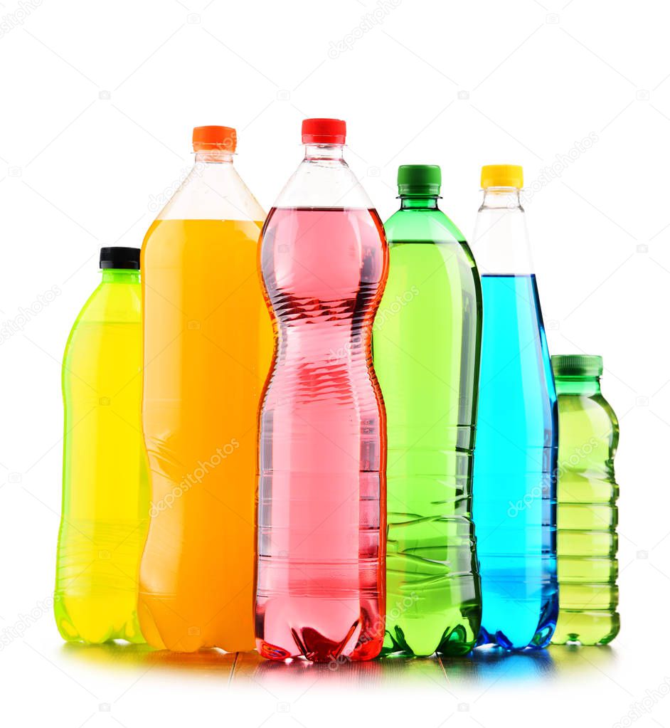 Plastic bottles of assorted carbonated soft drinks over white background