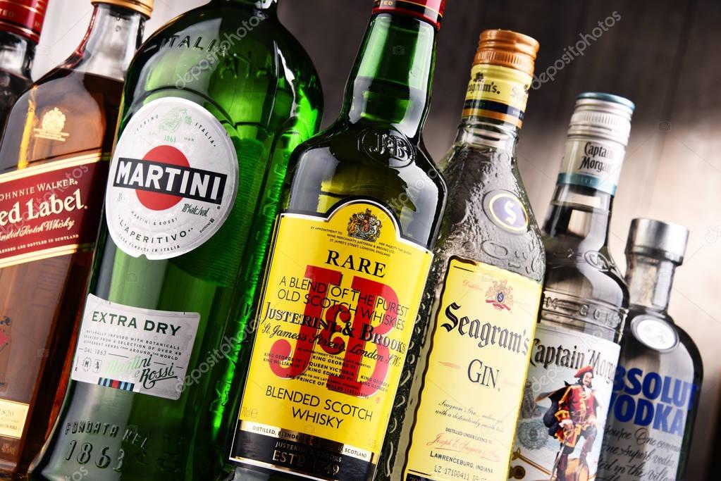 POZNAN, POLAND - DEC 15, 2017: Bottles of assorted global liquor brands including Martini, Johnnie Walker, Captain Morgan, Absolut Vodka, Seagram and JB