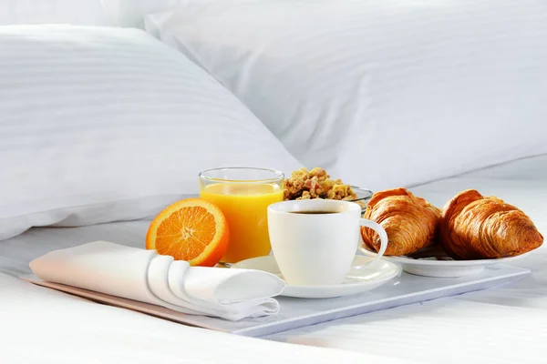 Breakfast in bed in hotel room.