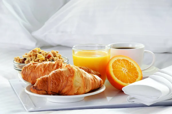 Breakfast in bed in hotel room.