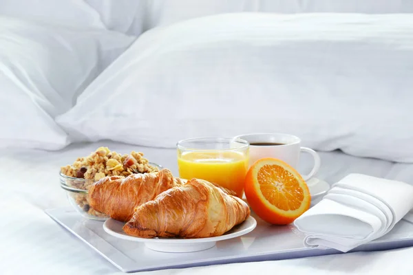 Breakfast in bed in hotel room.