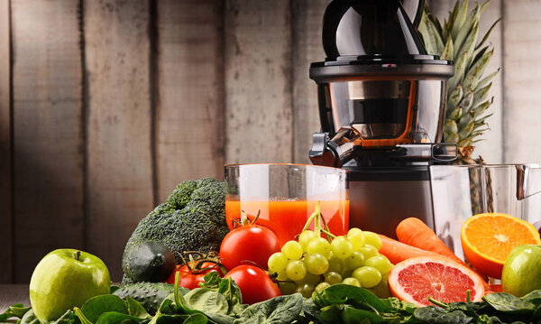 Slow juicer with organic fruits and vegetables.