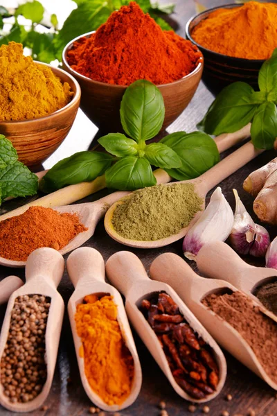 Variety of spices and herbs on kitchen table — Stock Photo, Image