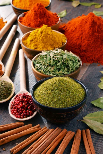 Variety of spices and herbs on kitchen table — Stock Photo, Image