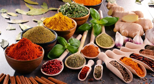 Variety of spices and herbs on kitchen table — Stock Photo, Image