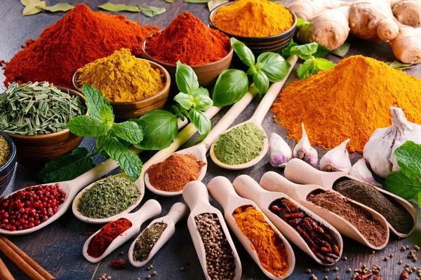 Variety of spices and herbs on kitchen table — Stock Photo, Image