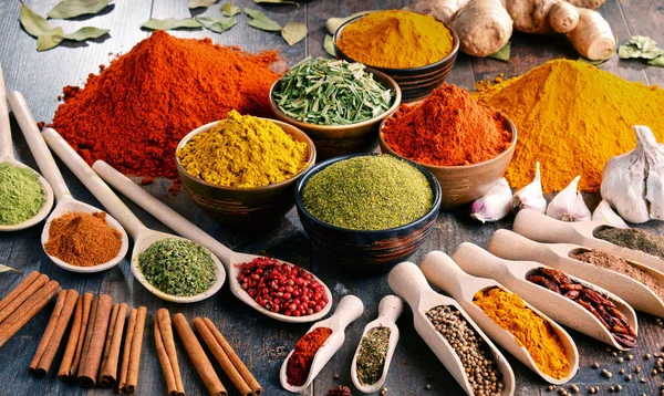 Variety of spices and herbs on kitchen table — Stock Photo, Image