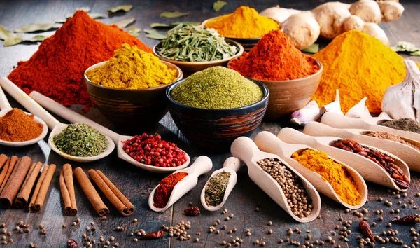 Variety of spices and herbs on kitchen table — Stock Photo, Image