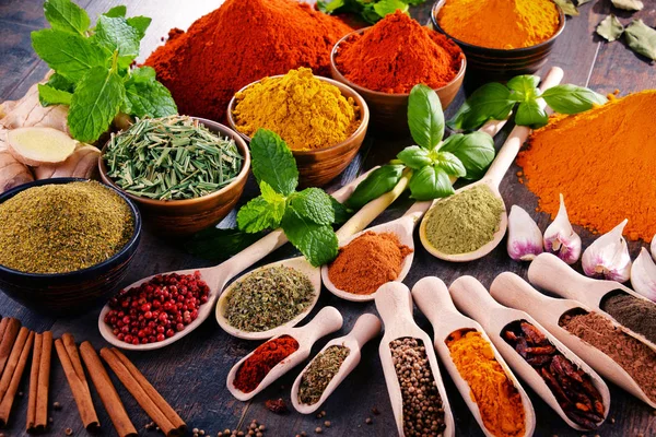 Variety of spices and herbs on kitchen table — Stock Photo, Image