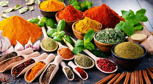 Variety of spices and herbs on kitchen table — Stock Photo, Image