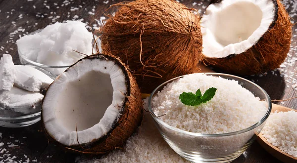 Composition with bowl of shredded coconut and shells