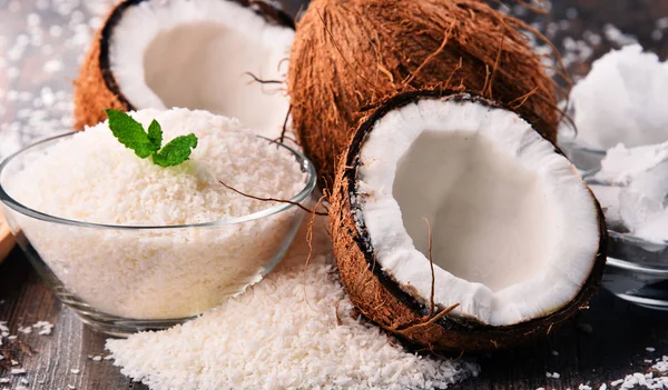 Composition with bowl of shredded coconut and shells