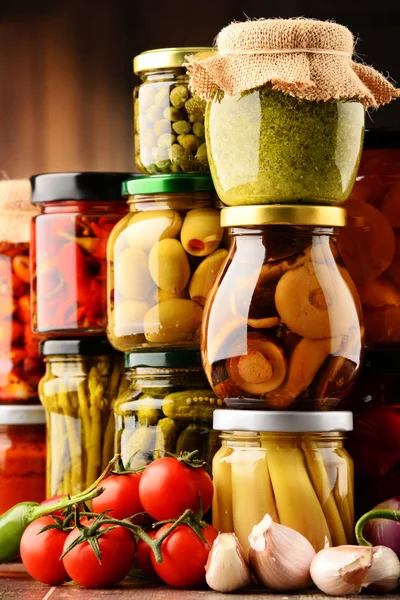 Jars with variety of pickled vegetables. — Stock Photo, Image