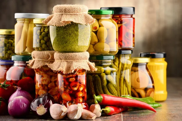 Jars with variety of pickled vegetables. — Stock Photo, Image