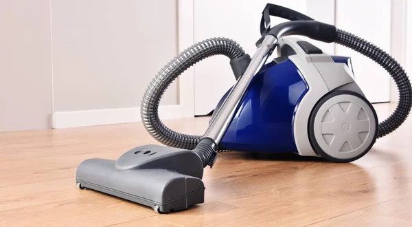 Canister vacuum cleaner for home use on the floor panels — Stock Photo, Image