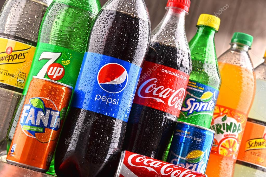 POZNAN, POLAND - DEC 15, 2017: Bottles of global soft drink brands including products of Coca Cola Company and Pepsico