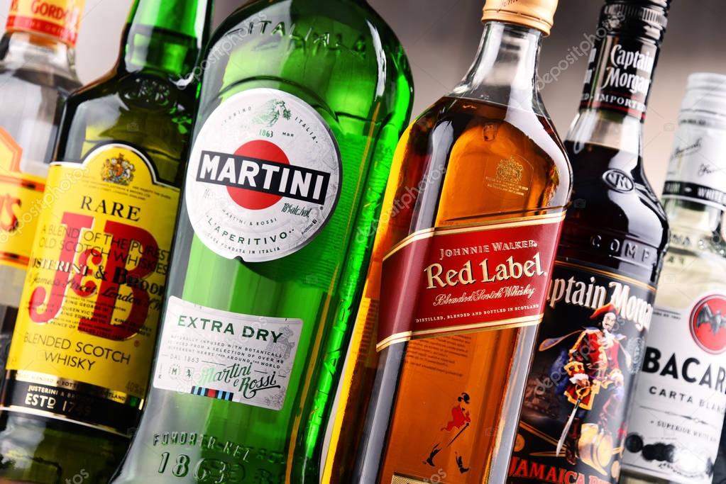 POZNAN, POLAND - DEC 15, 2017: Bottles of assorted global liquor brands including Martini, Johnnie Walker, Captain Morgan, Bacardi