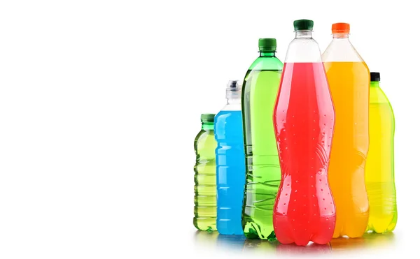 Plastic bottles of assorted carbonated soft drinks over white — Stock Photo, Image