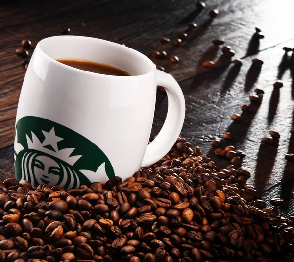 Composition with cup of Starbucks coffee and beans — Stock Photo, Image