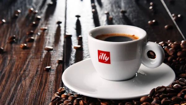 Composição com xícara de café Illy e grãos — Fotografia de Stock