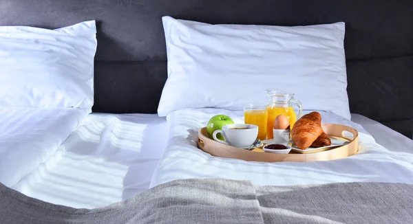 Frühstück auf Tablett im Bett im Hotelzimmer — Stockfoto