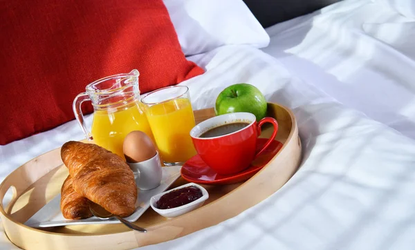 Desayuno en bandeja en la cama en la habitación del hotel —  Fotos de Stock
