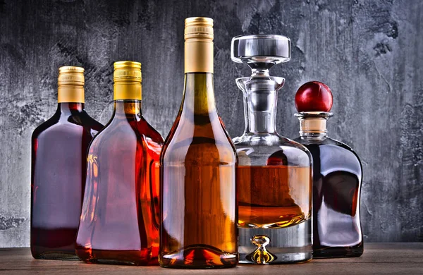 Carafe and bottles of assorted alcoholic beverages. — Stock Photo, Image