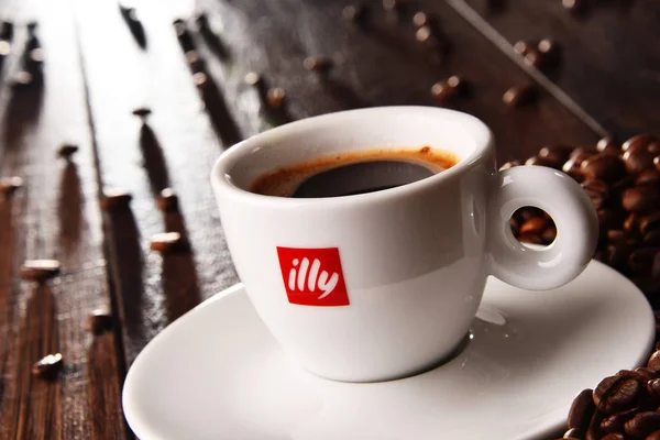 Composição com xícara de café Illy e grãos — Fotografia de Stock