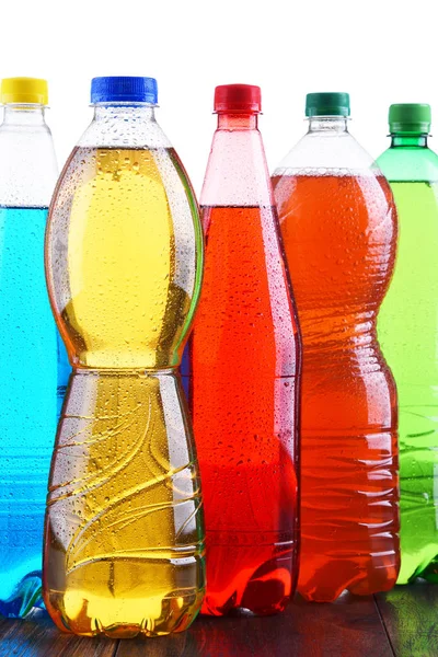 Plastic bottles of assorted carbonated soft drinks — Stock Photo, Image